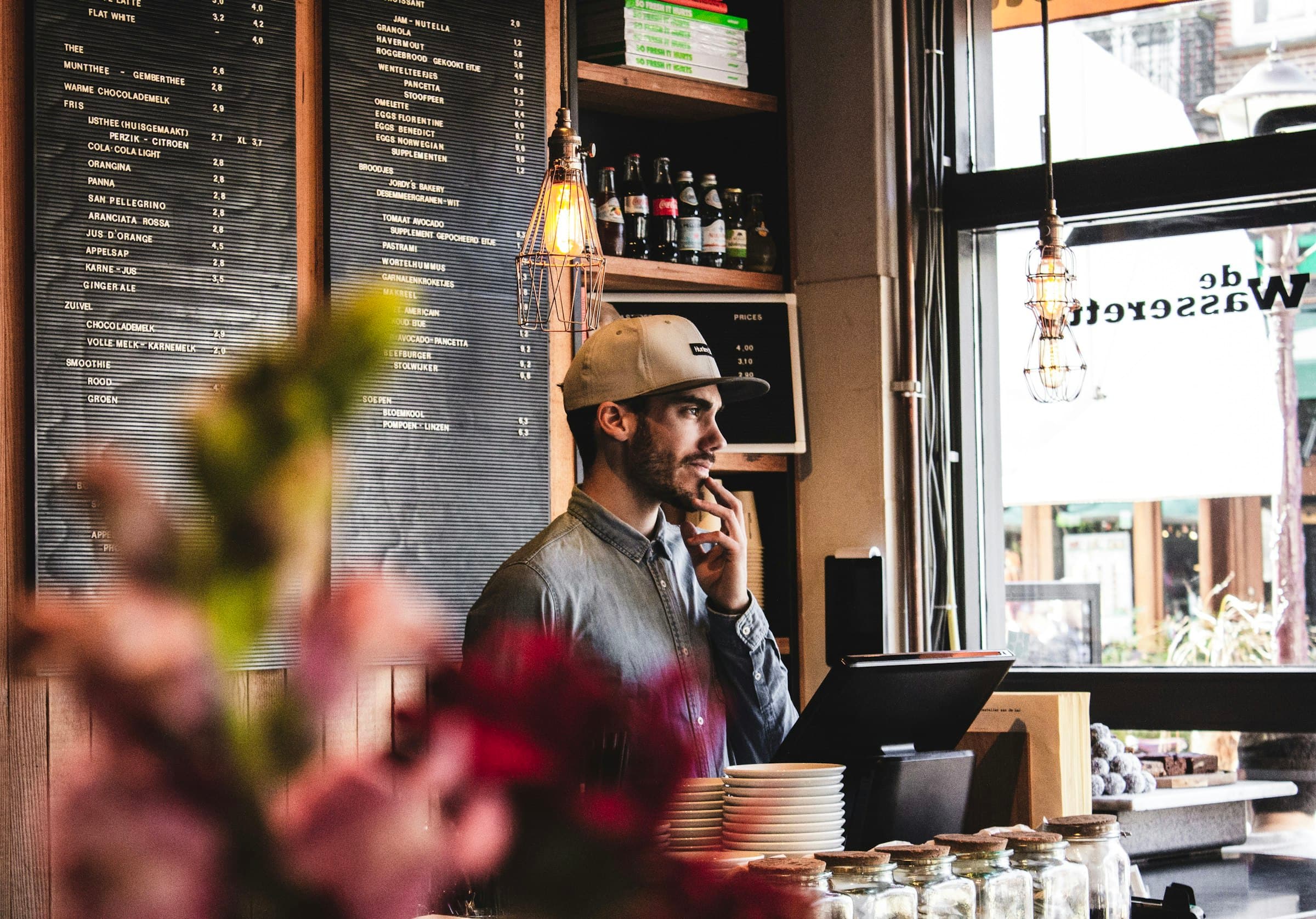 Small-business owner behind the counter of a cafe